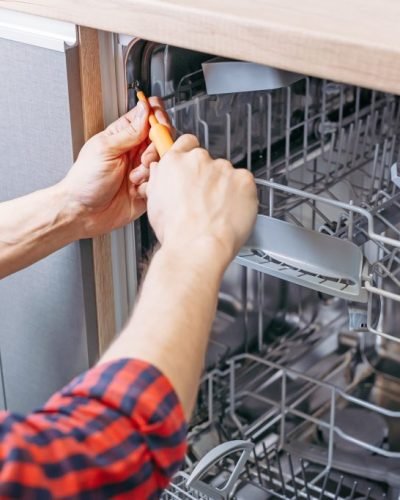 man-repairing-dishwasher-male-hand-with-screwdriv-2023-11-27-05-09-59-utc-1-1024x683